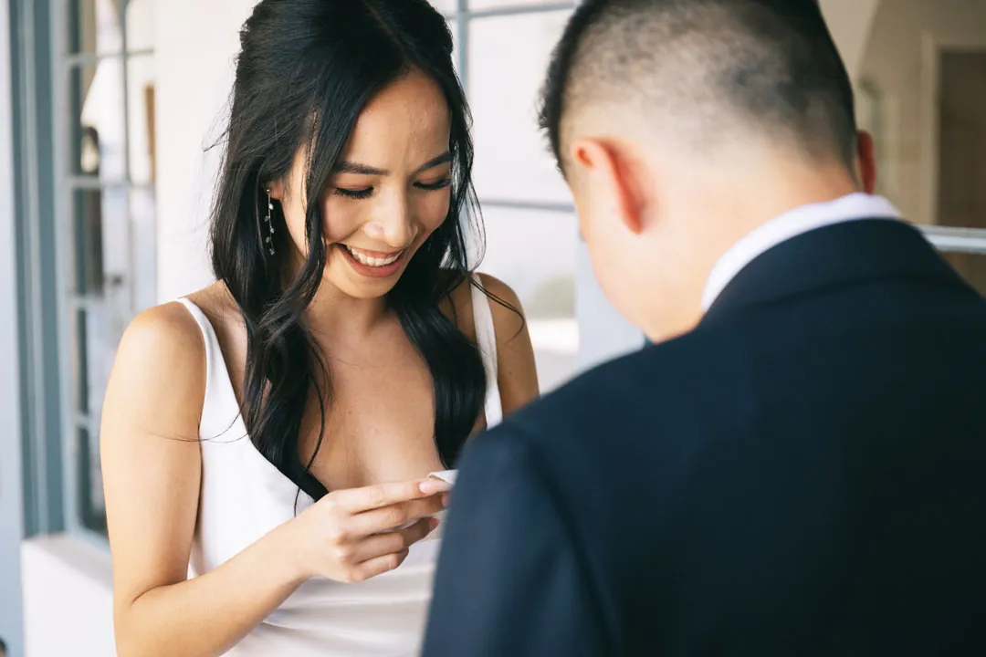 Bride reading from a booklet to the groom
