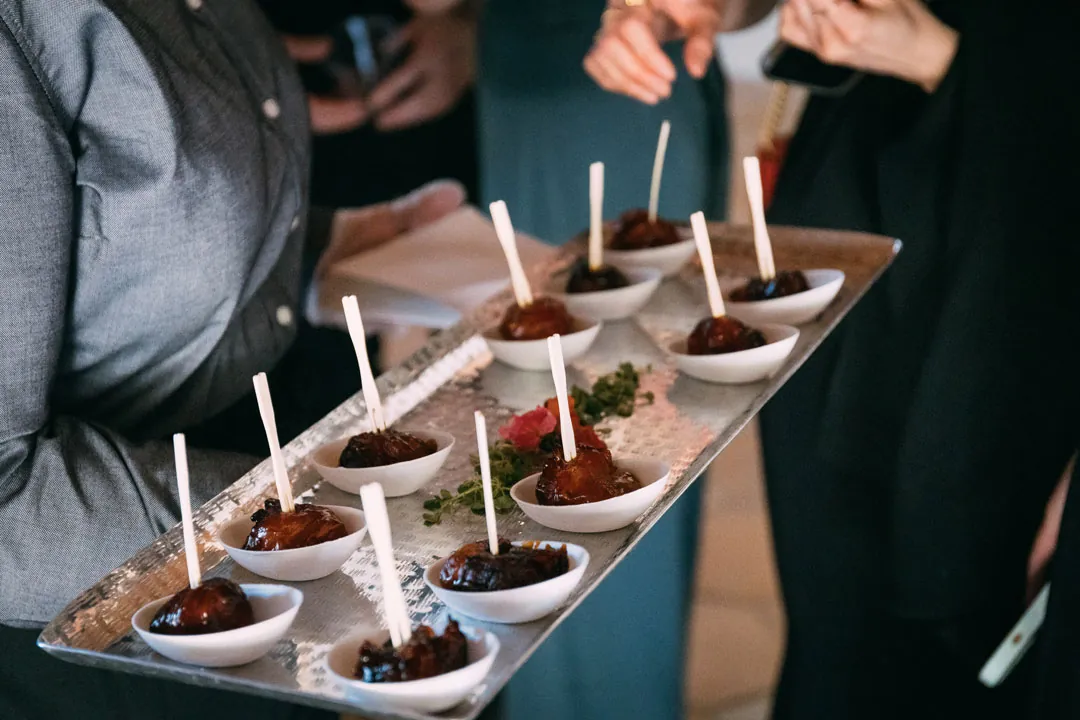 Small appetizers served in individual bowls with skewers