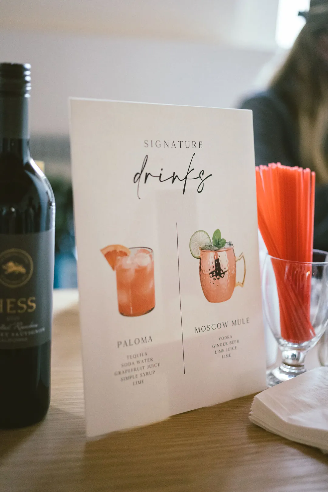Illustrated signature drinks menu on the wooden bar