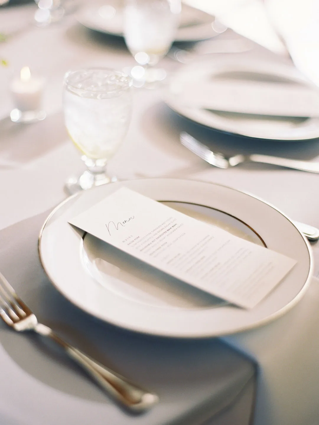 Printed menu on a pale reception place setting