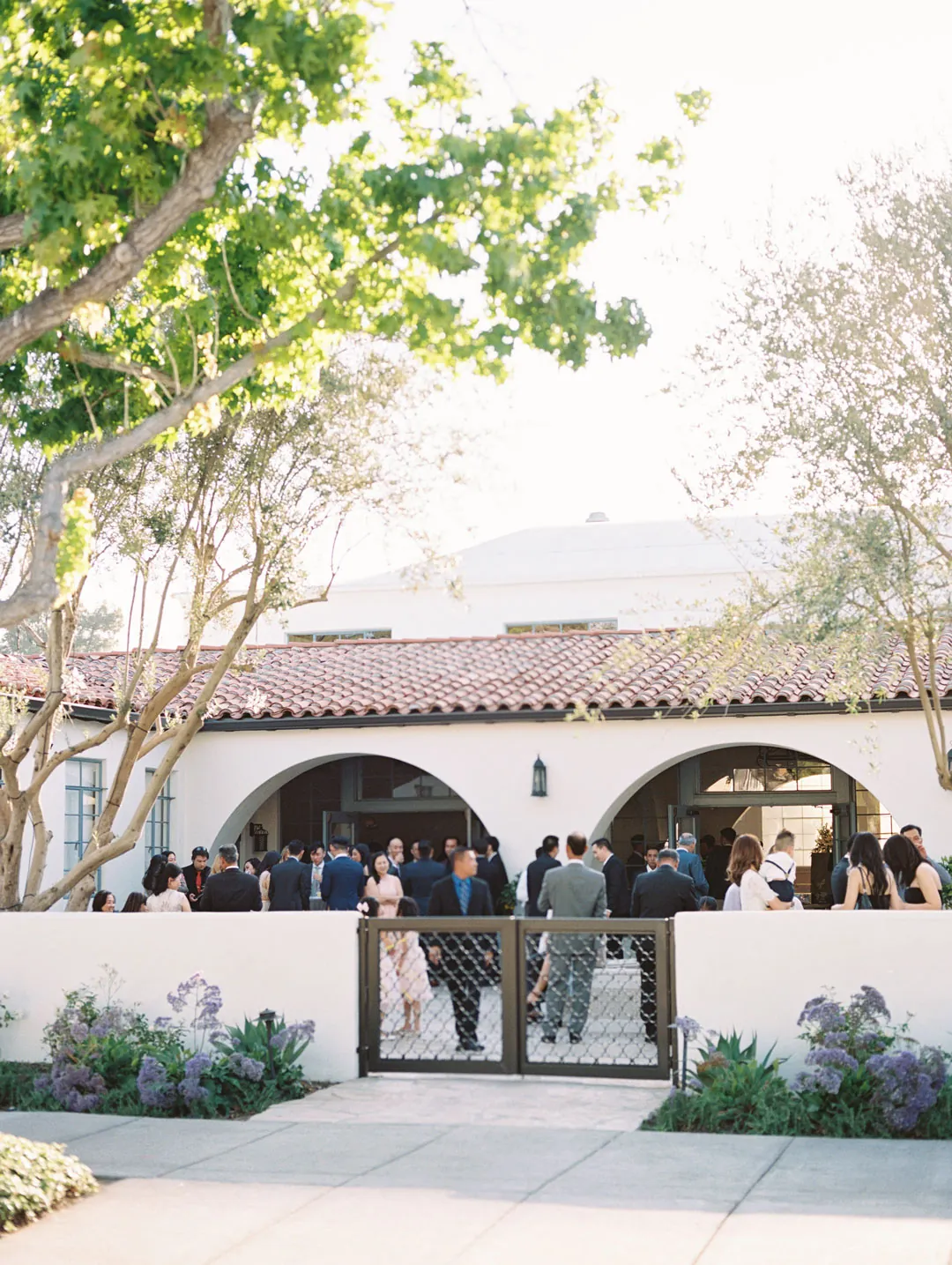 Venue entrance beyond a landscaped courtyard walkway