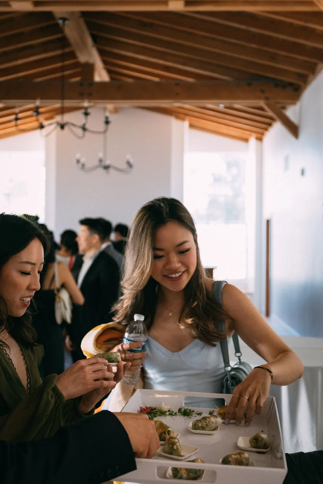 Wedding guests selecting food inside the reception hall