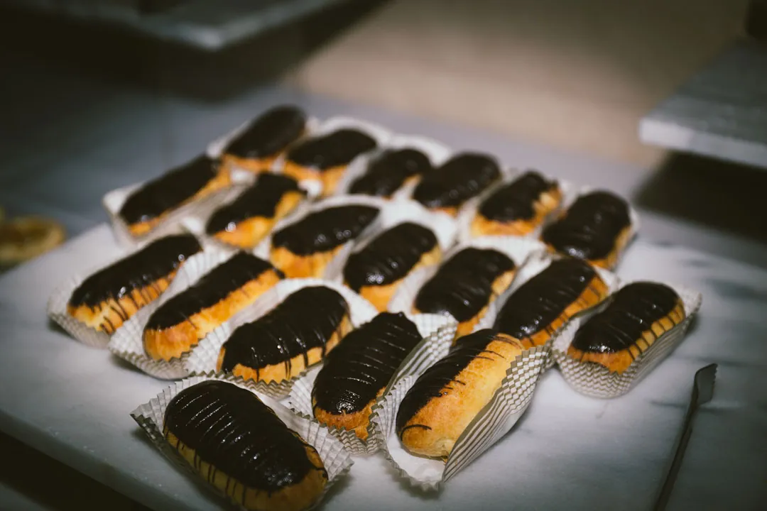Chocolate-topped pastries arranged on a dessert platter.