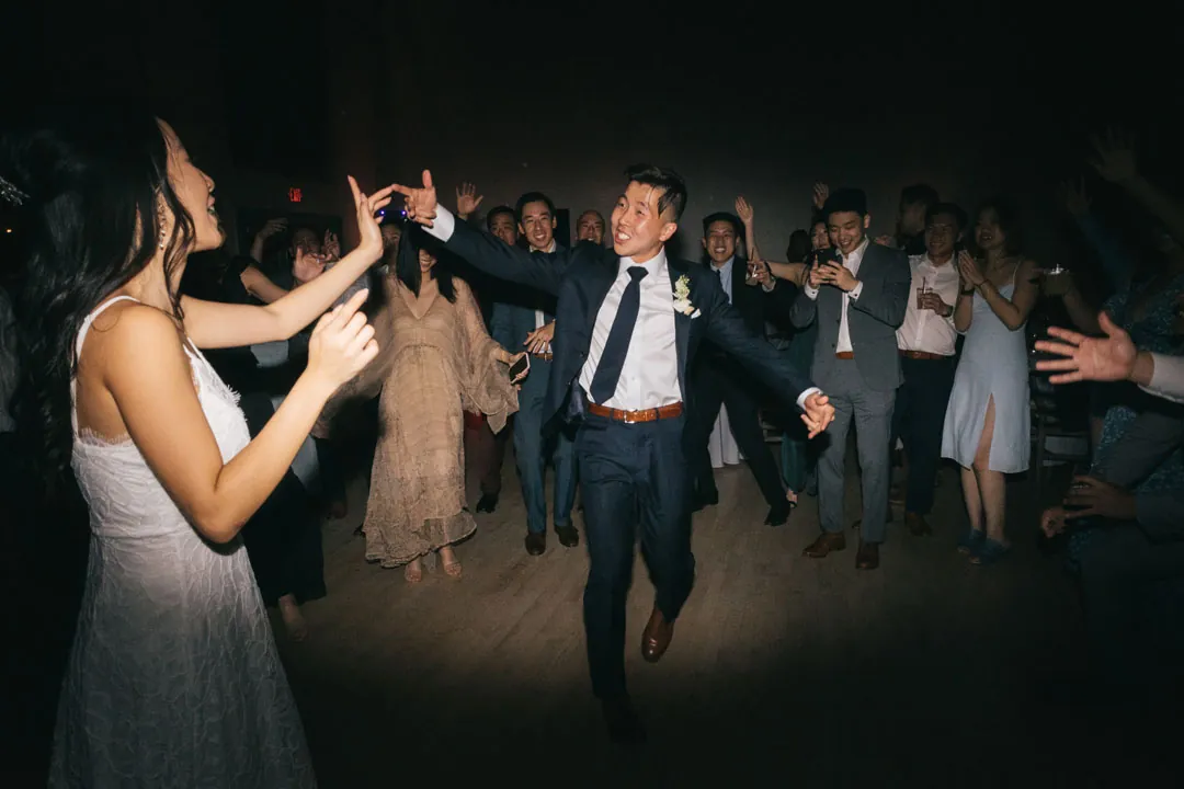 Groom dancing with guests during the evening reception.