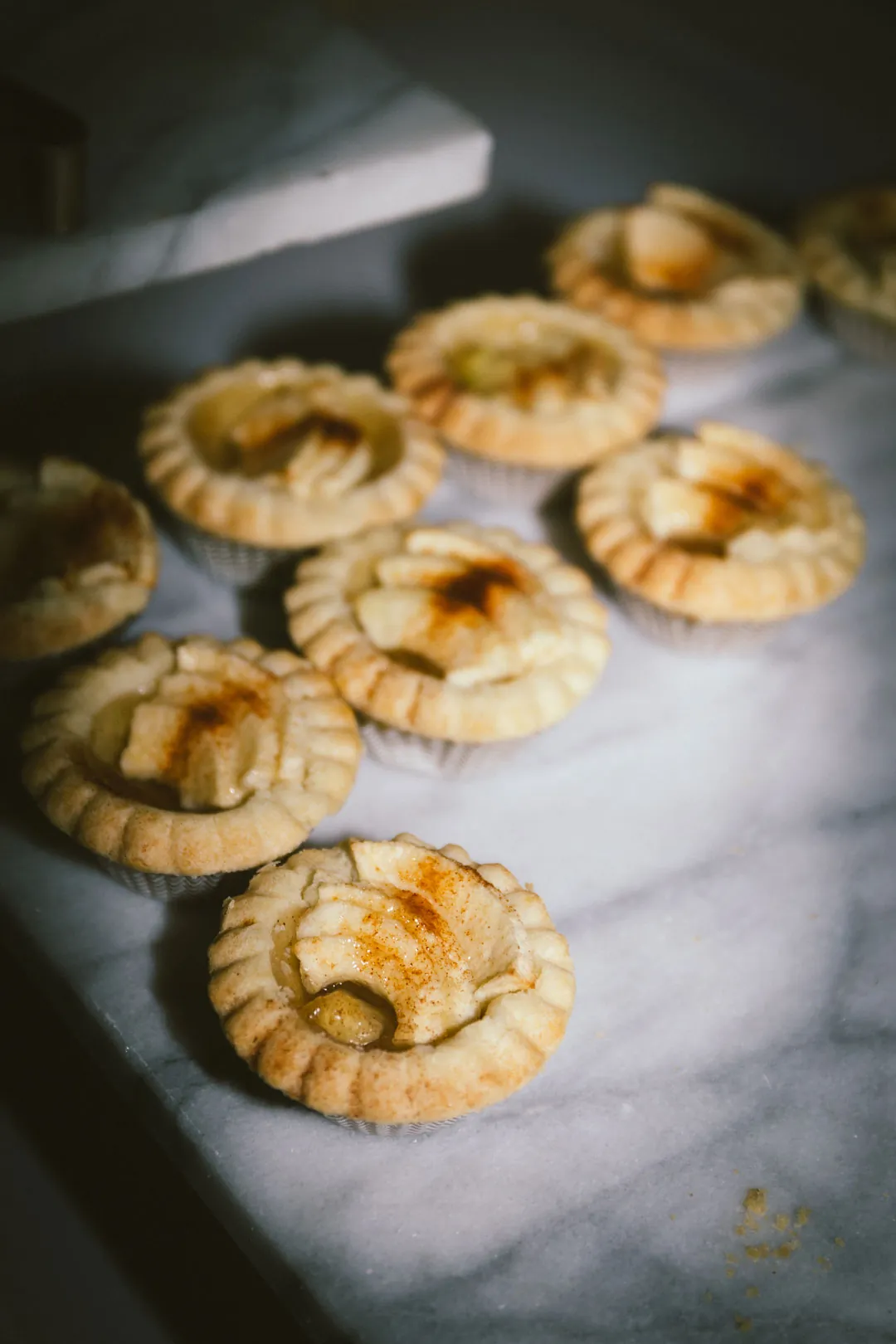 Small fruit tartlets on a serving platter.