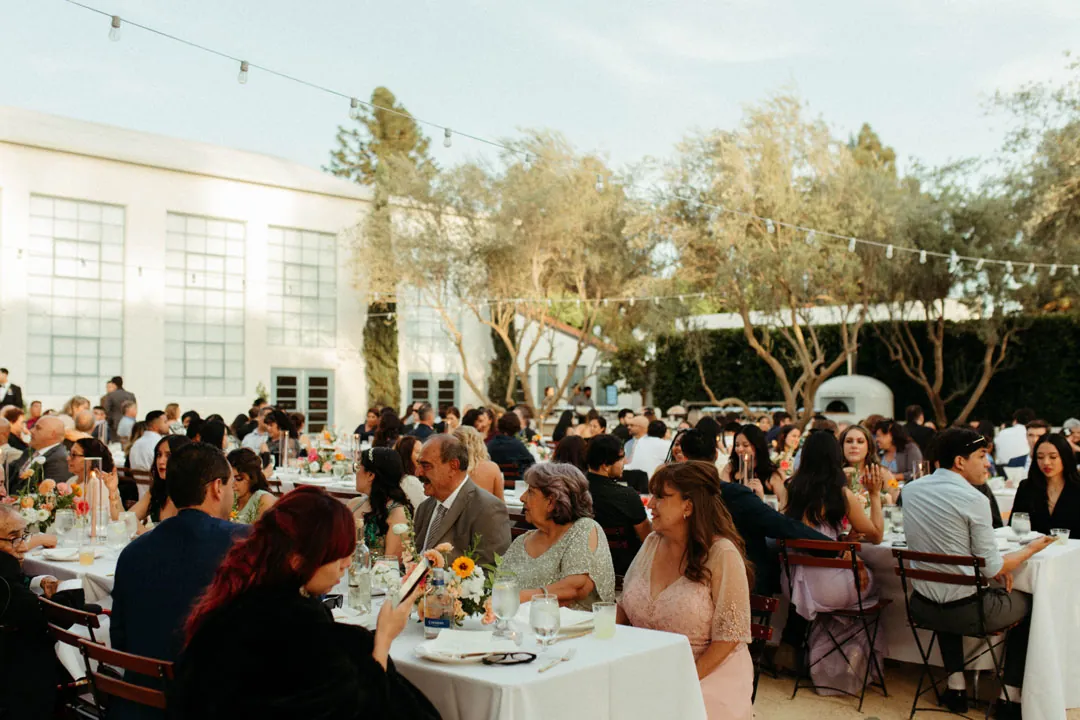 Guests dining at round courtyard tables
