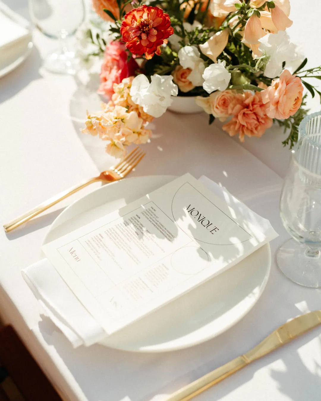 Printed menu beside a colorful floral centerpiece