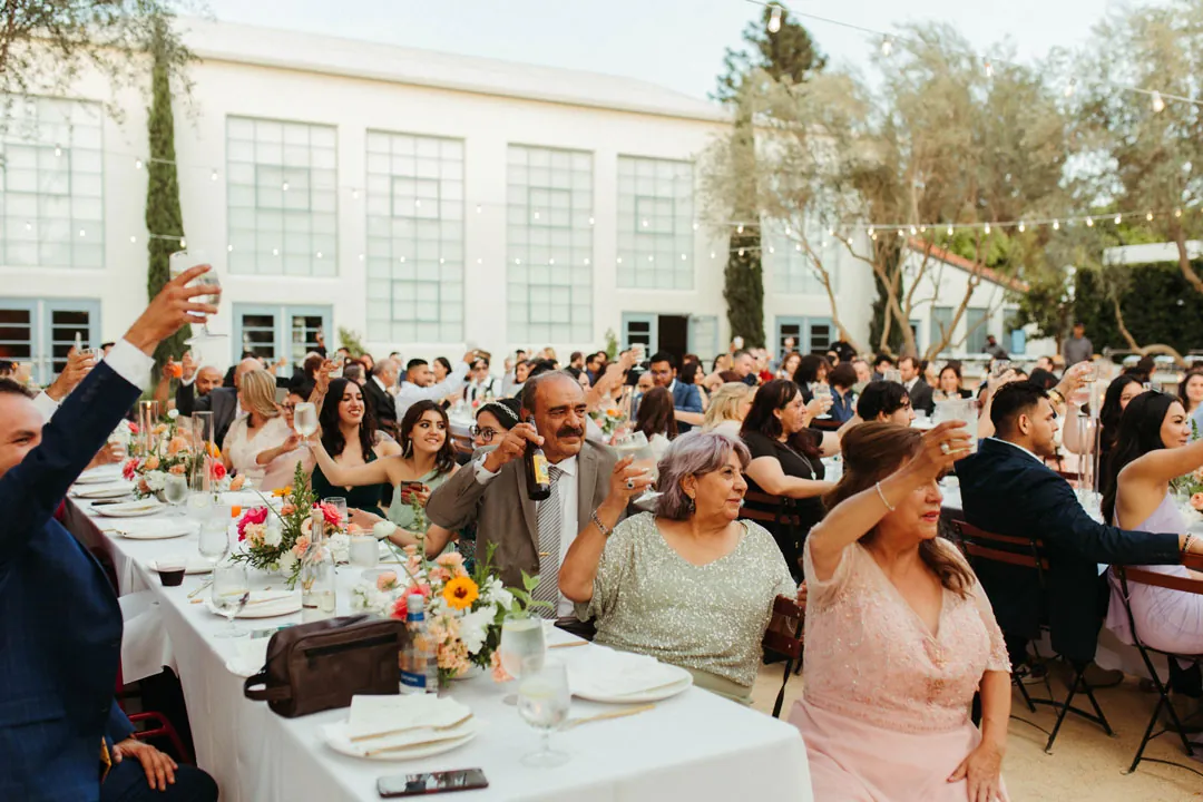 Guests raising glasses together in a toast