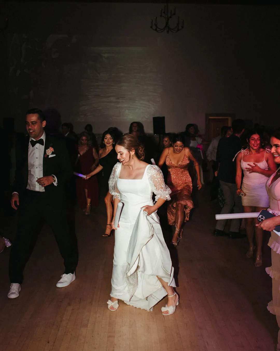 Bride and groom dancing together after dark