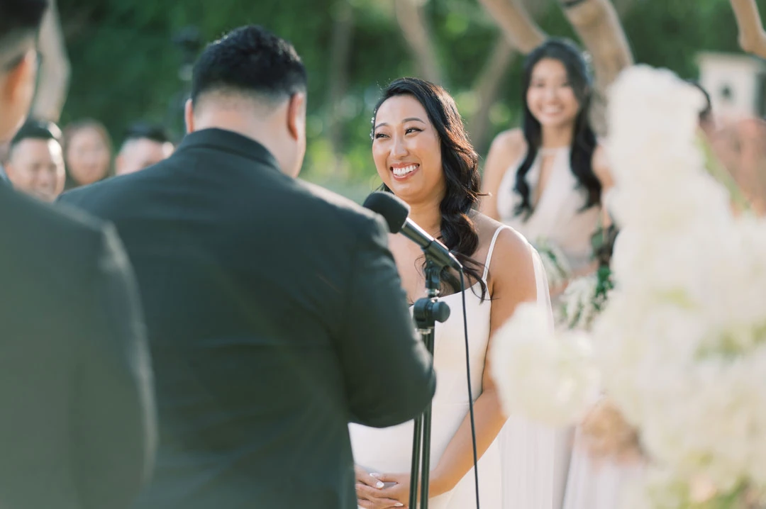 Bride smiling at the groom during their ceremony