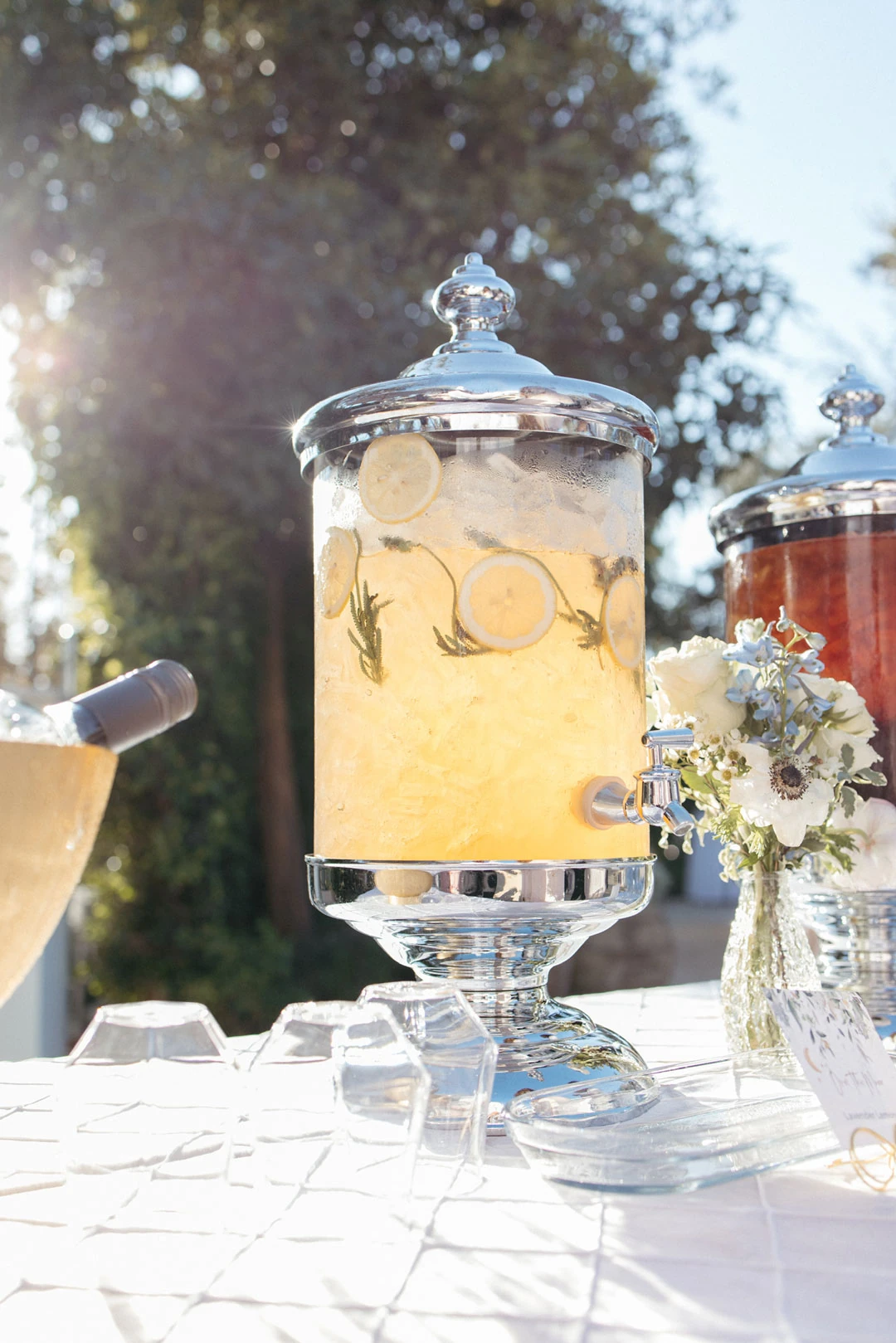 Glass beverage dispenser filled with citrus slices.