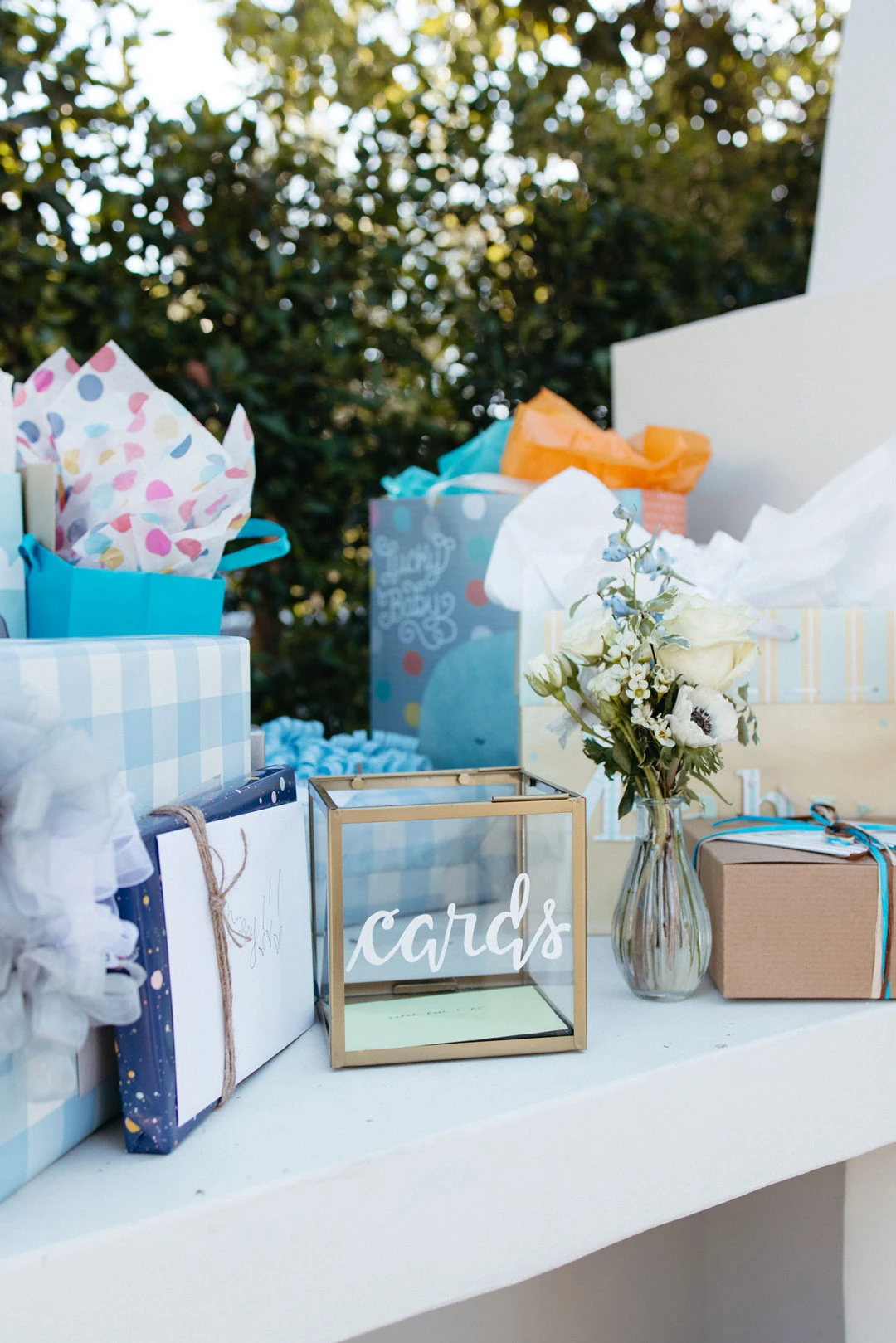 Wrapped gifts and a card box on a table.