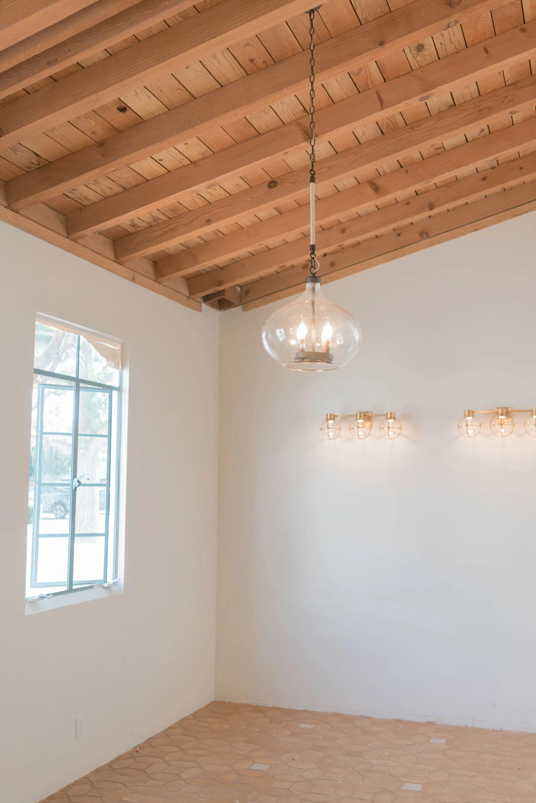 Wooden ceiling and tile floor in an empty room.
