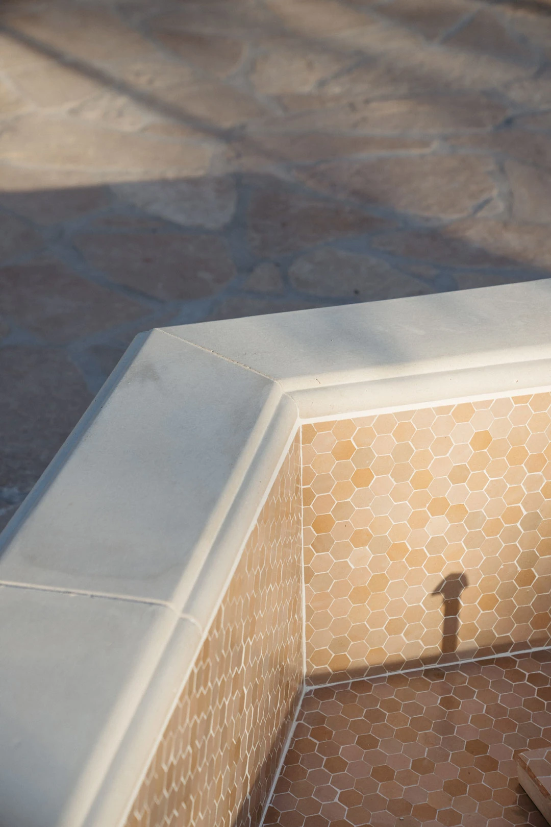 Tiled courtyard fountain viewed from above.