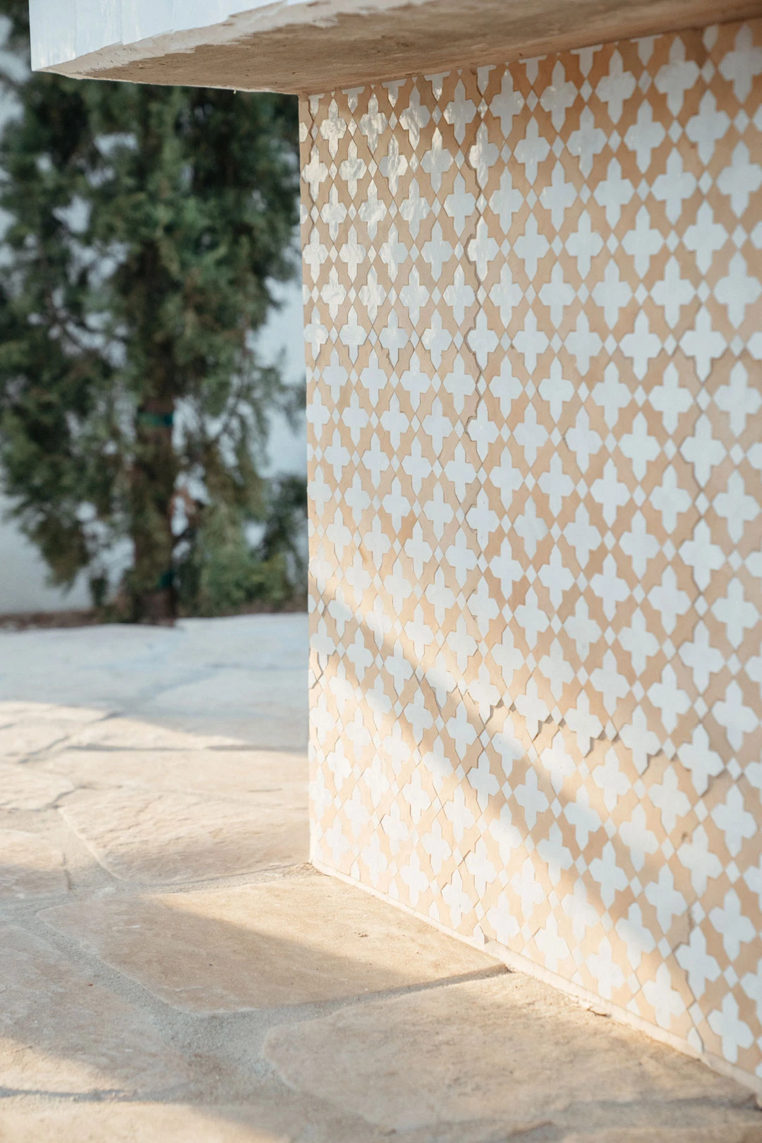 Patterned tile covers an outdoor counter.