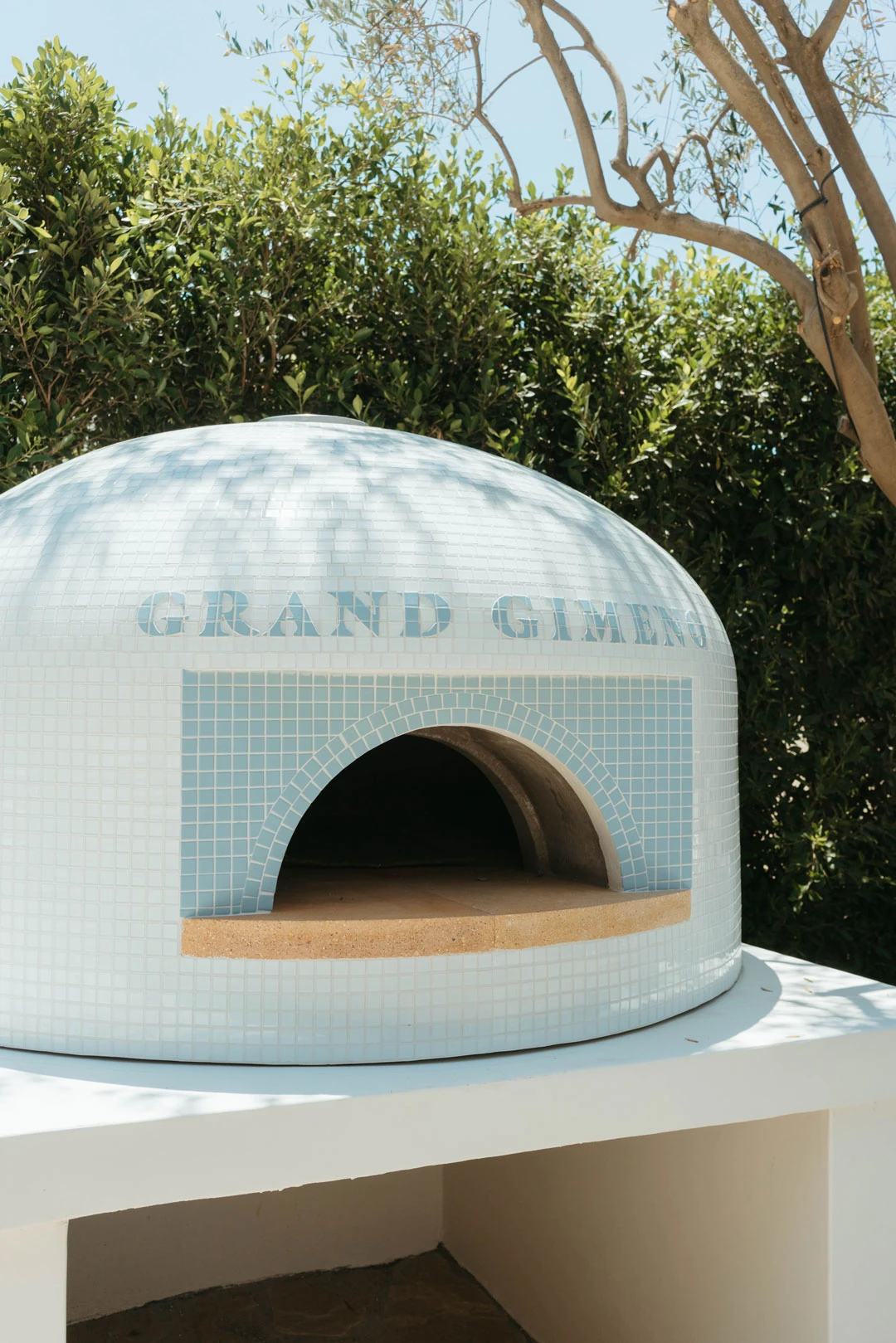 Domed pizza oven on an outdoor counter.