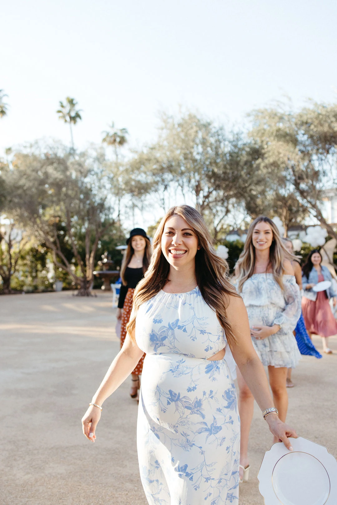 Guests walk through the courtyard beneath trees.
