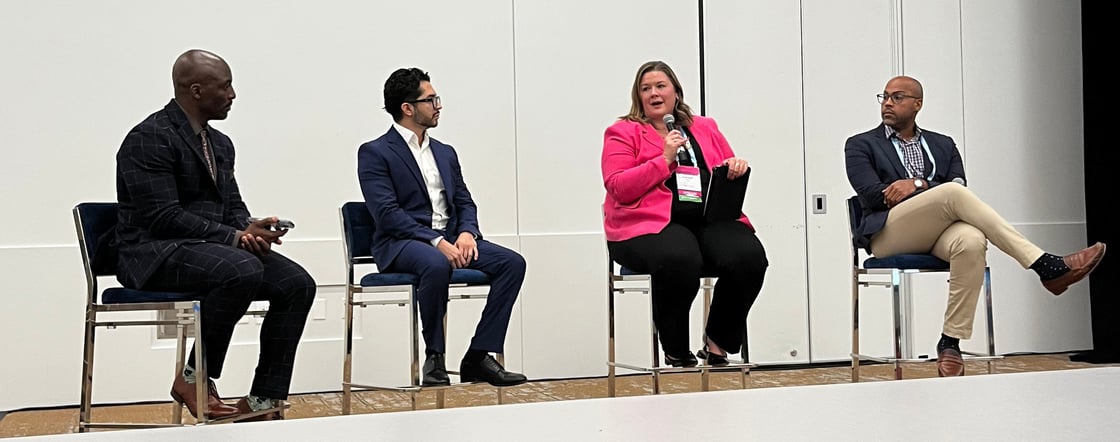 Speakers on stage at the Boardrooms to Break Rooms panel.