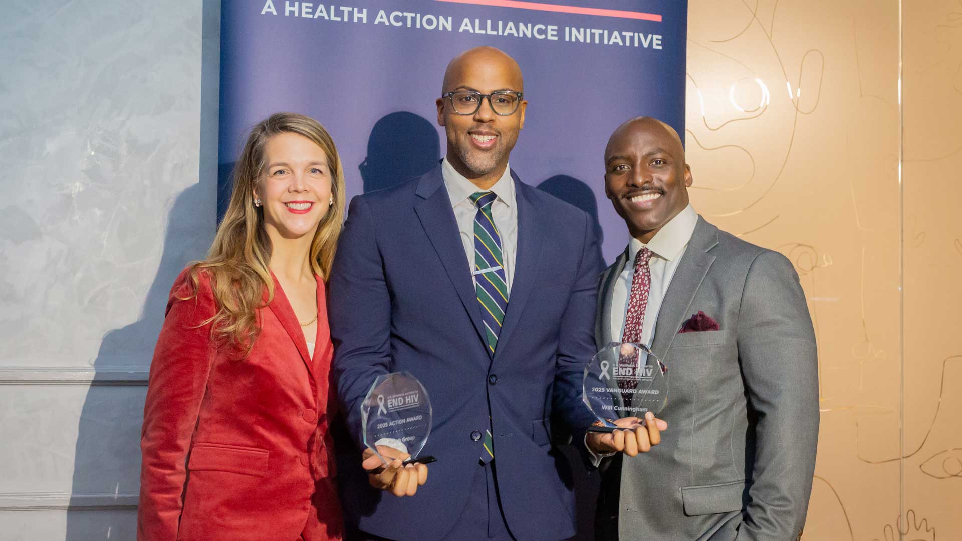 Match Group's Will Cunningham, center, is flanked by U.S. Business Action to End HIV Directors Caroline Jackson and Mario Harper after accepting the 2025 Vanguard Award and 2025 Action Award.