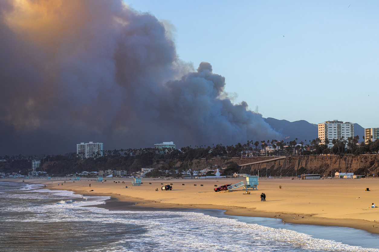 Wildfire smoke billows over a beach in Los Angeles.