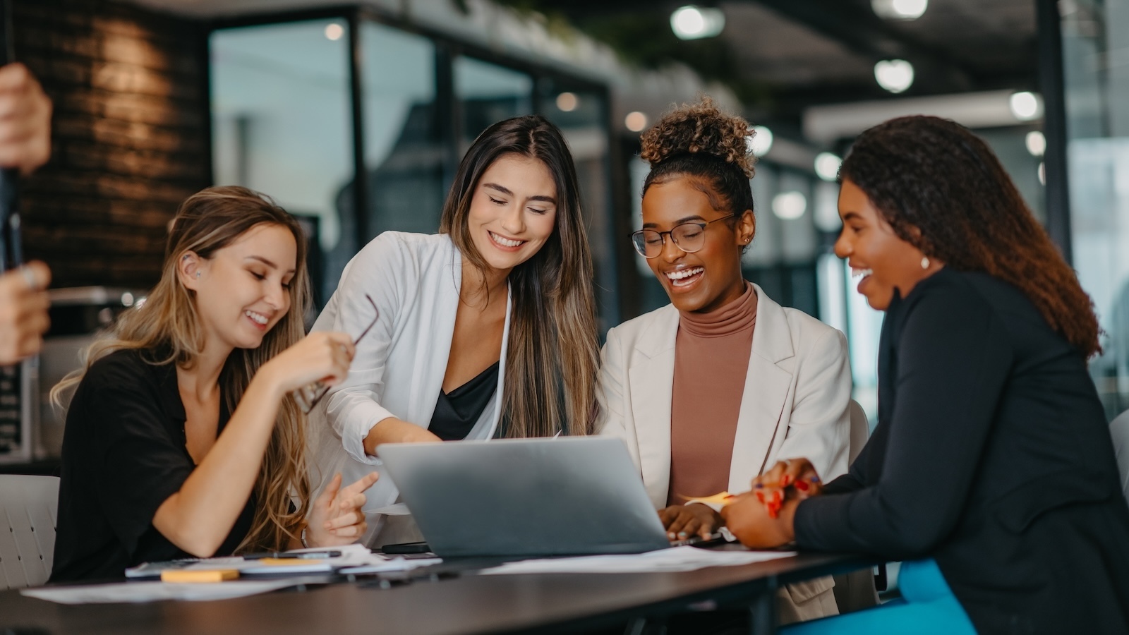 Women sitting at a desk working together. 