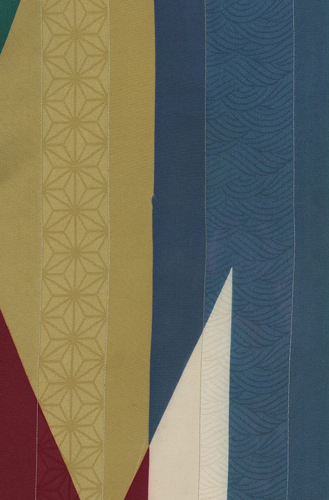 Abstract geometric textile with geometric patterns in yellow, blue, and red