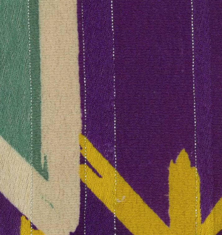 Textile with vertical stripes in purple, green, beige, and yellow