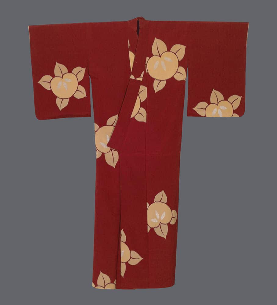 Red Japanese kimono with large yellow floral pattern on gray background