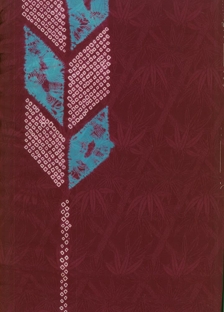 Blue and white geometric patterns on burgundy textured fabric background