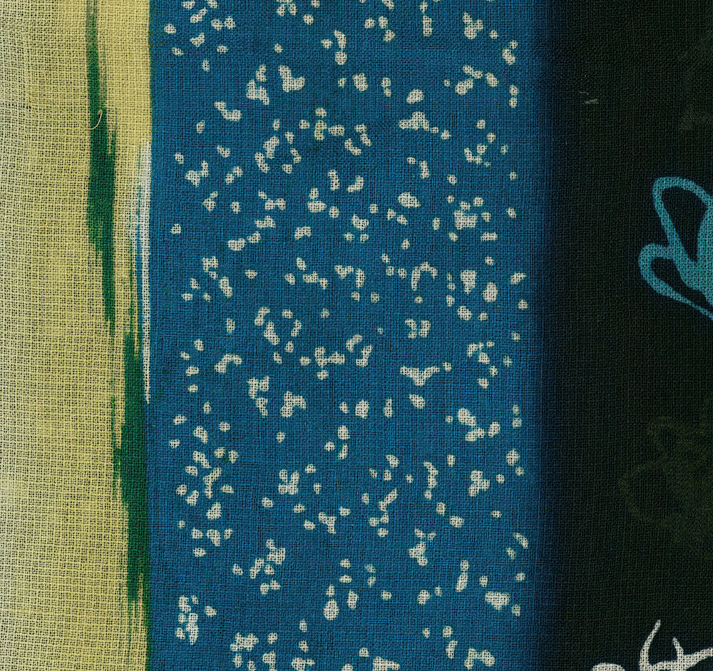 Blue textile with scattered white specks and green-yellow border