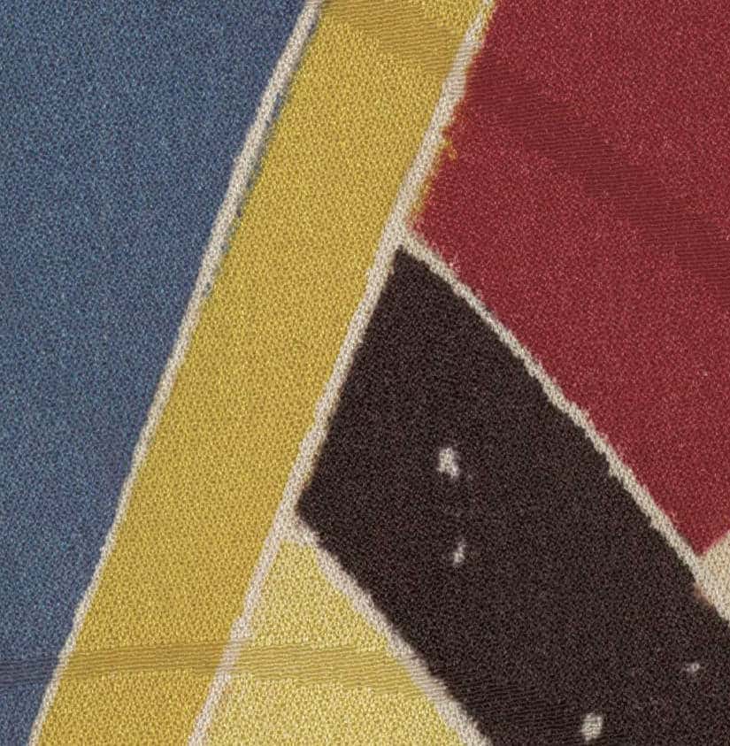 Abstract textile with geometric color blocks of blue, yellow, red, and black