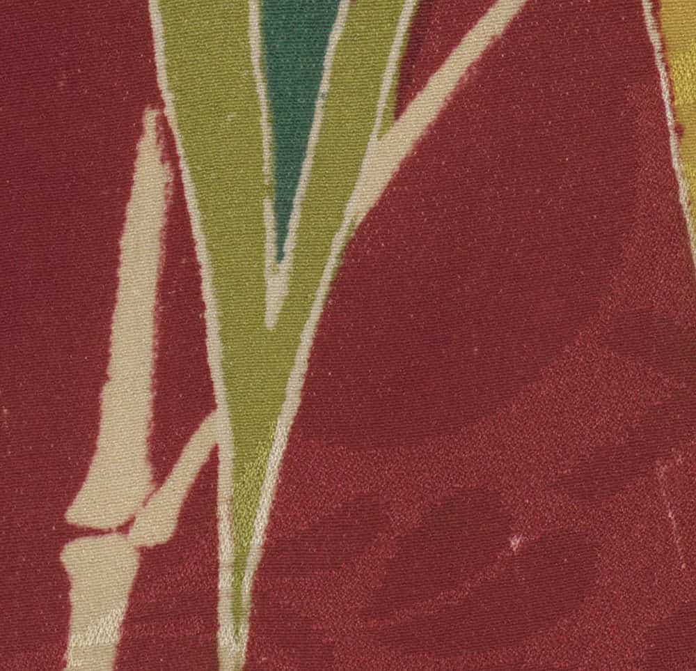 Abstract fabric pattern with red, green, and cream diagonal stripes