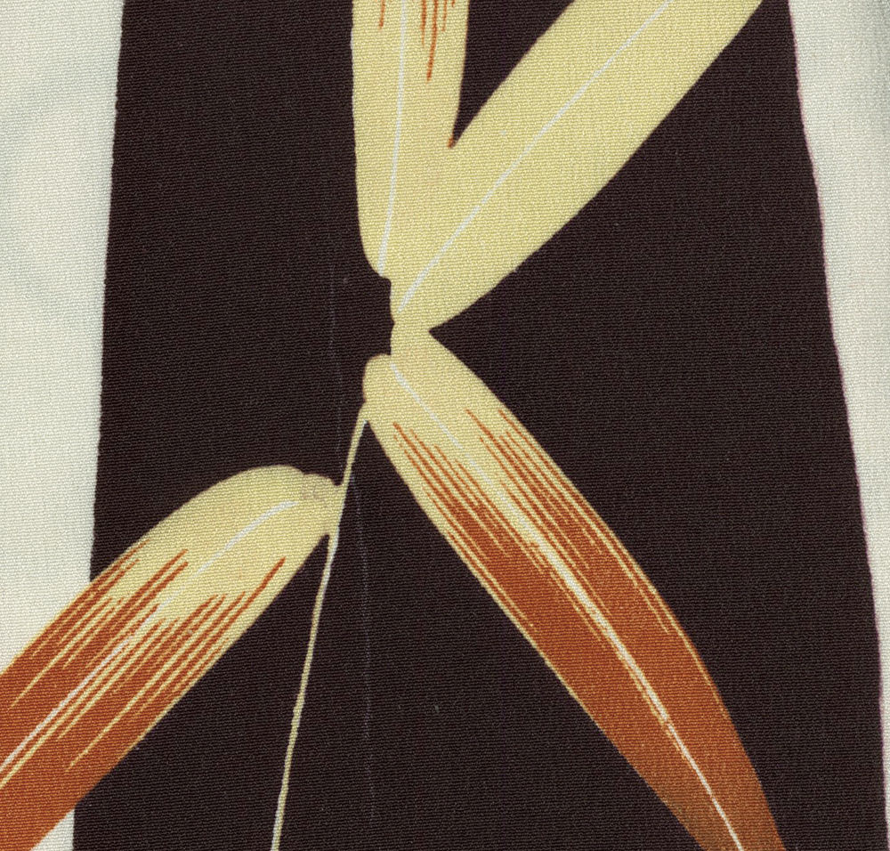 Abstract geometric fabric with yellow, black, and orange angular shapes