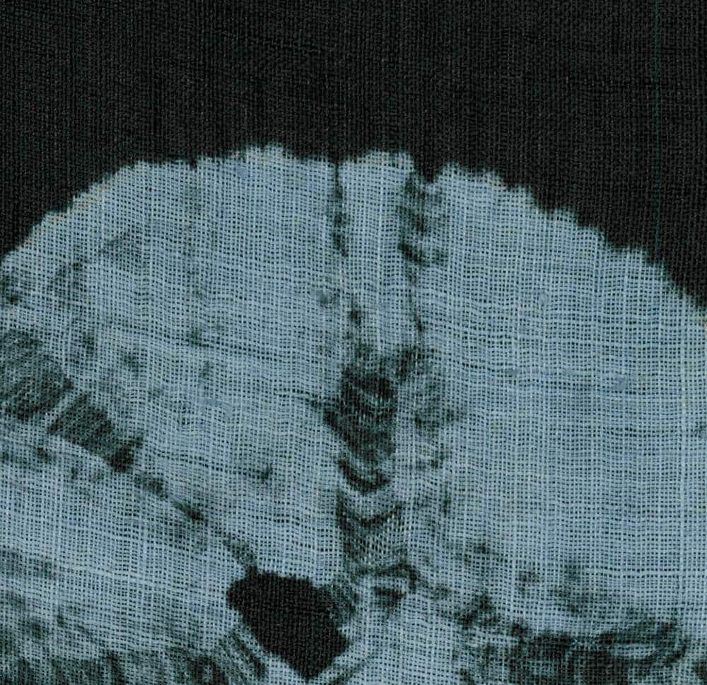 Tie-dye blue and black textured fabric with abstract pattern