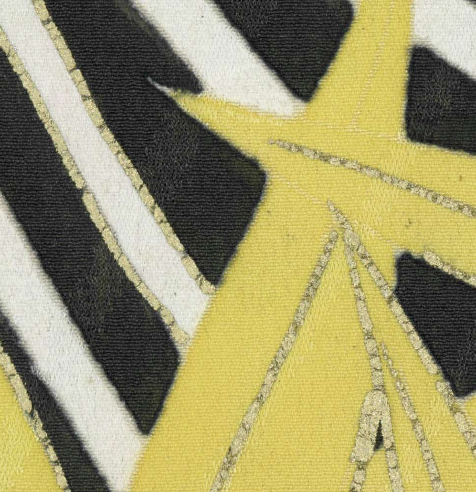 Close-up of yellow, black, and white textured fabric with abstract pattern