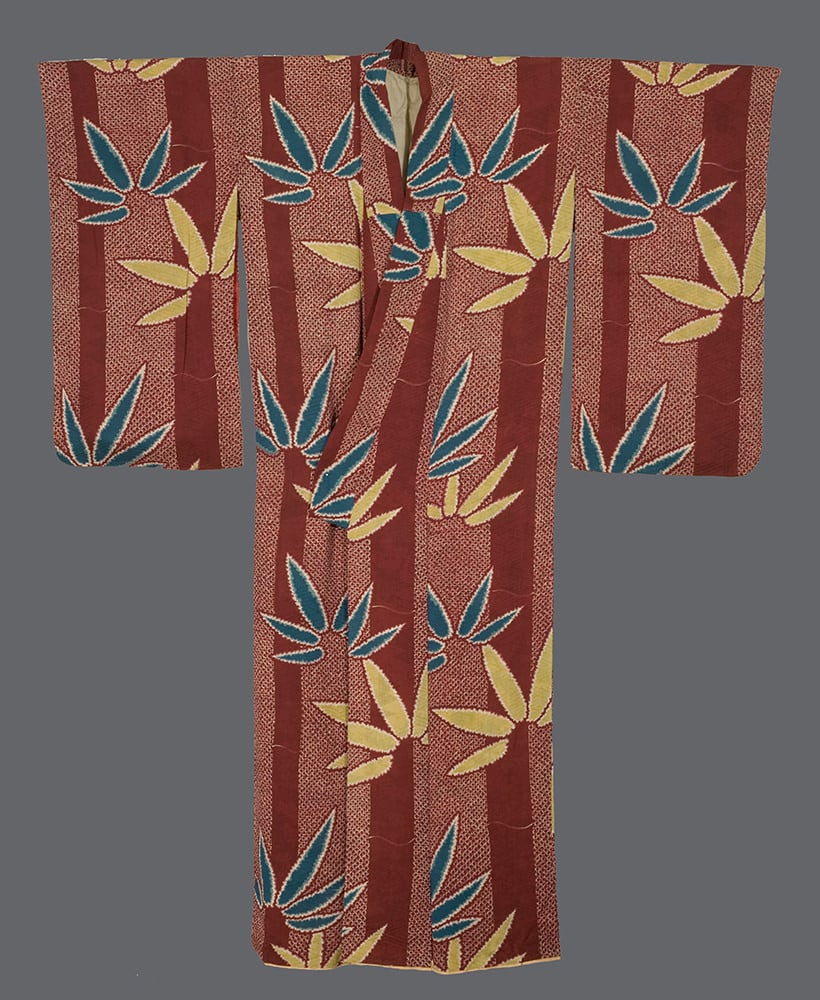 Vintage Japanese kimono with red background and yellow-blue leaf pattern