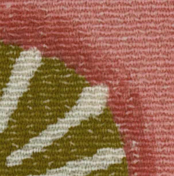 Textured fabric with green leaf pattern on pink-red background