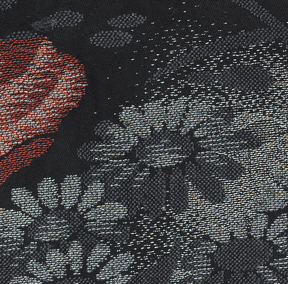 Textured fabric with red and gray geometric pattern and floral motifs