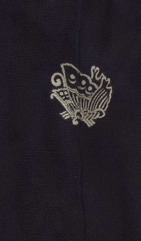 Metallic embroidered stylized bird design on black textured fabric