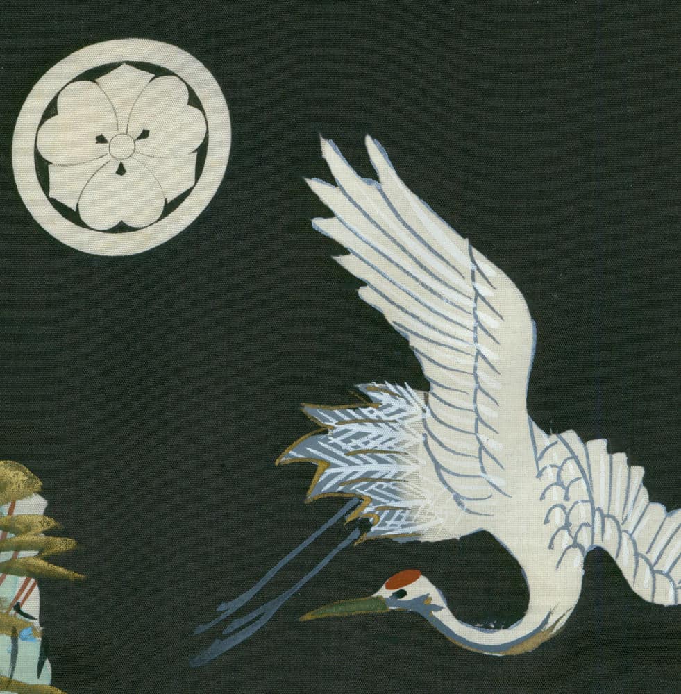 White crane in flight against dark background with traditional Japanese emblem