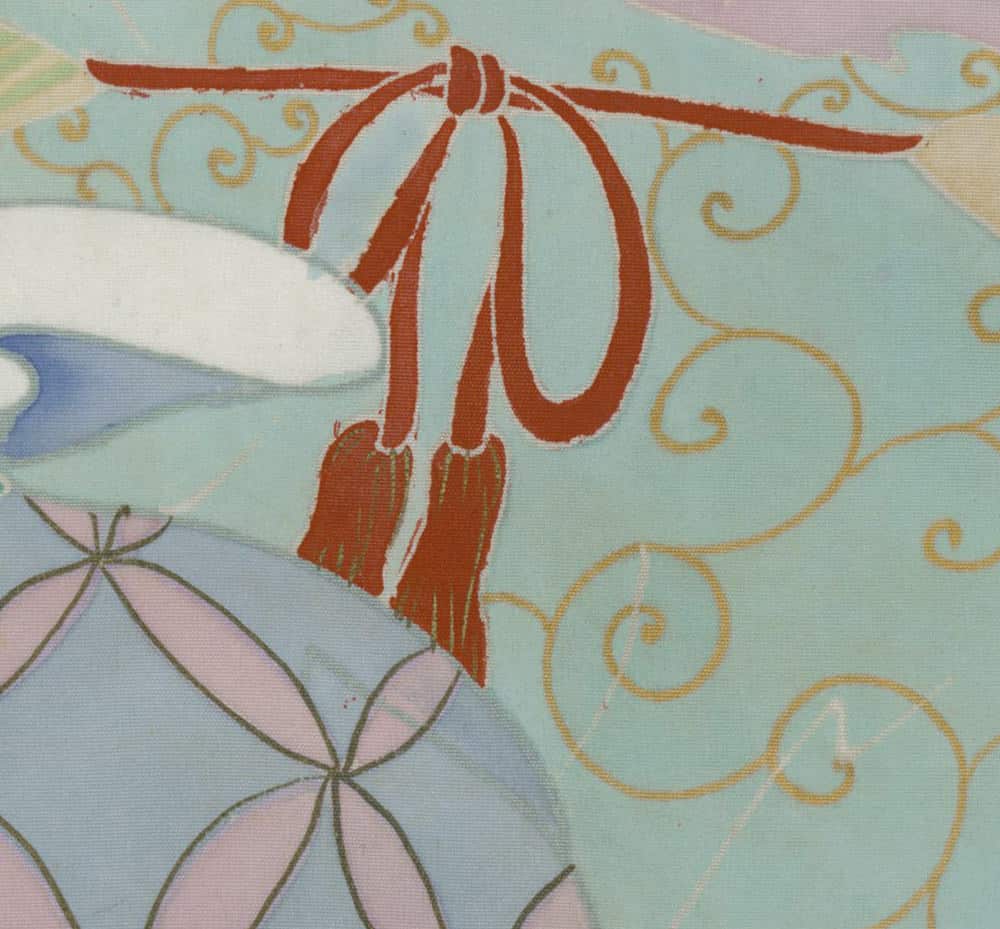 Red tasseled decoration on pastel background with floral and swirl patterns