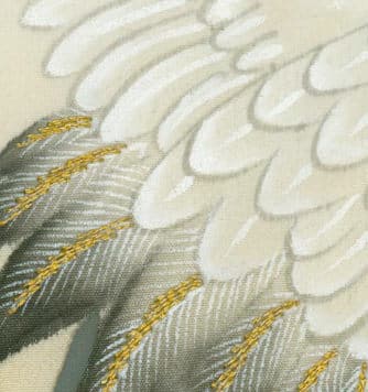 Detailed close-up of white feathers with golden yellow accents
