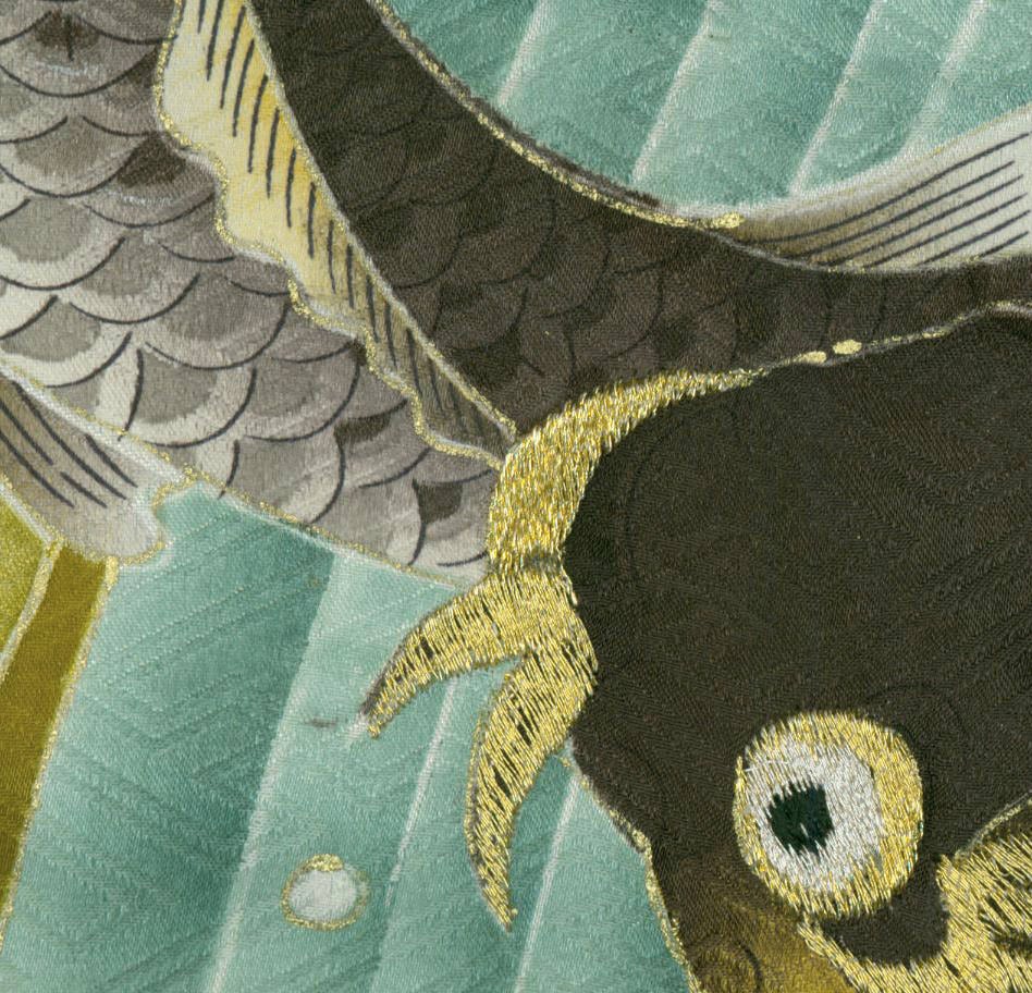 Abstract embroidered artwork with scales, gold threads, and green-blue tones