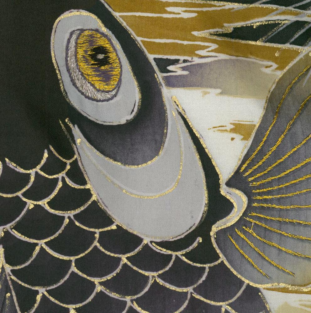 Embroidered mythical creature with golden eye and scale-like pattern