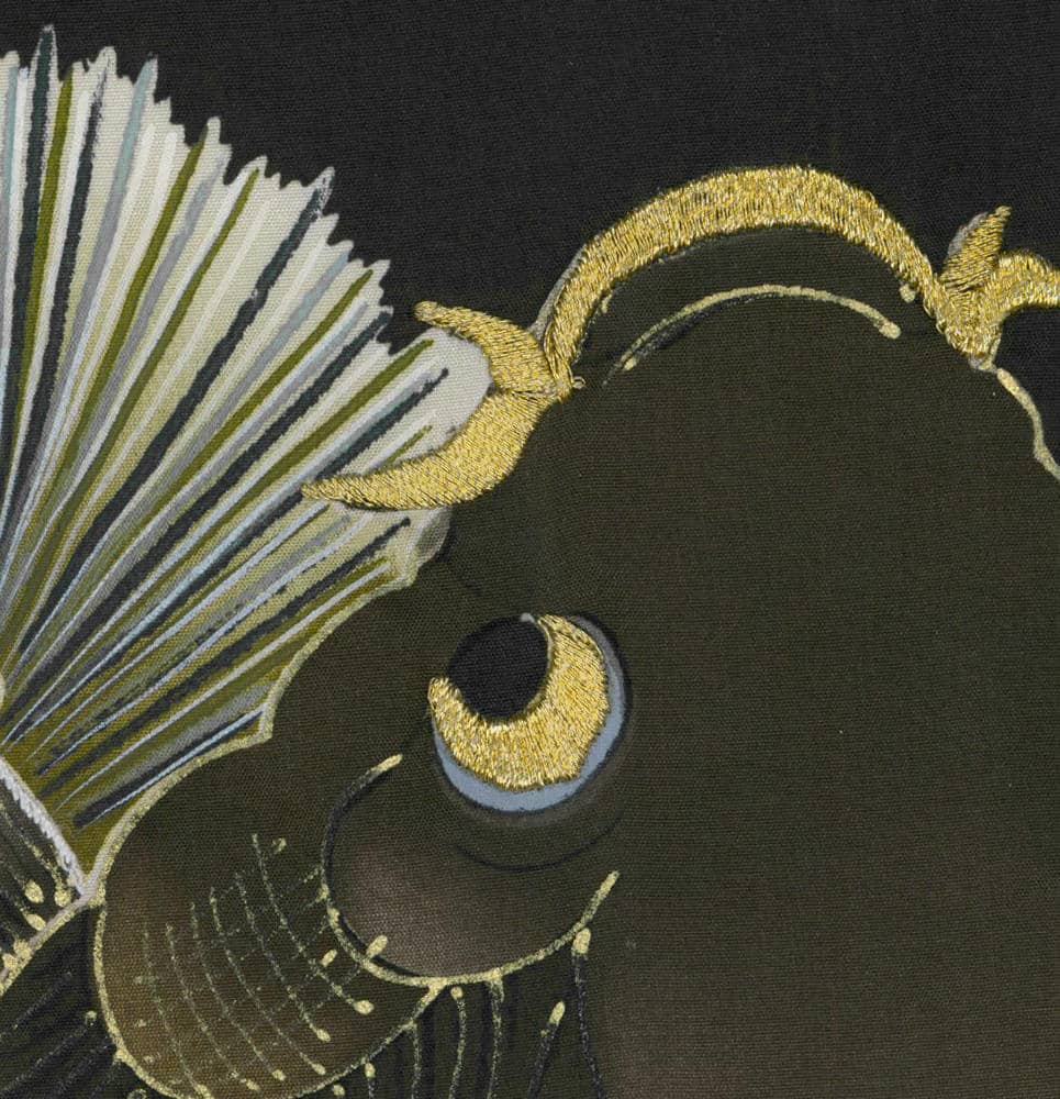 Embroidered abstract design with golden threads on dark green fabric