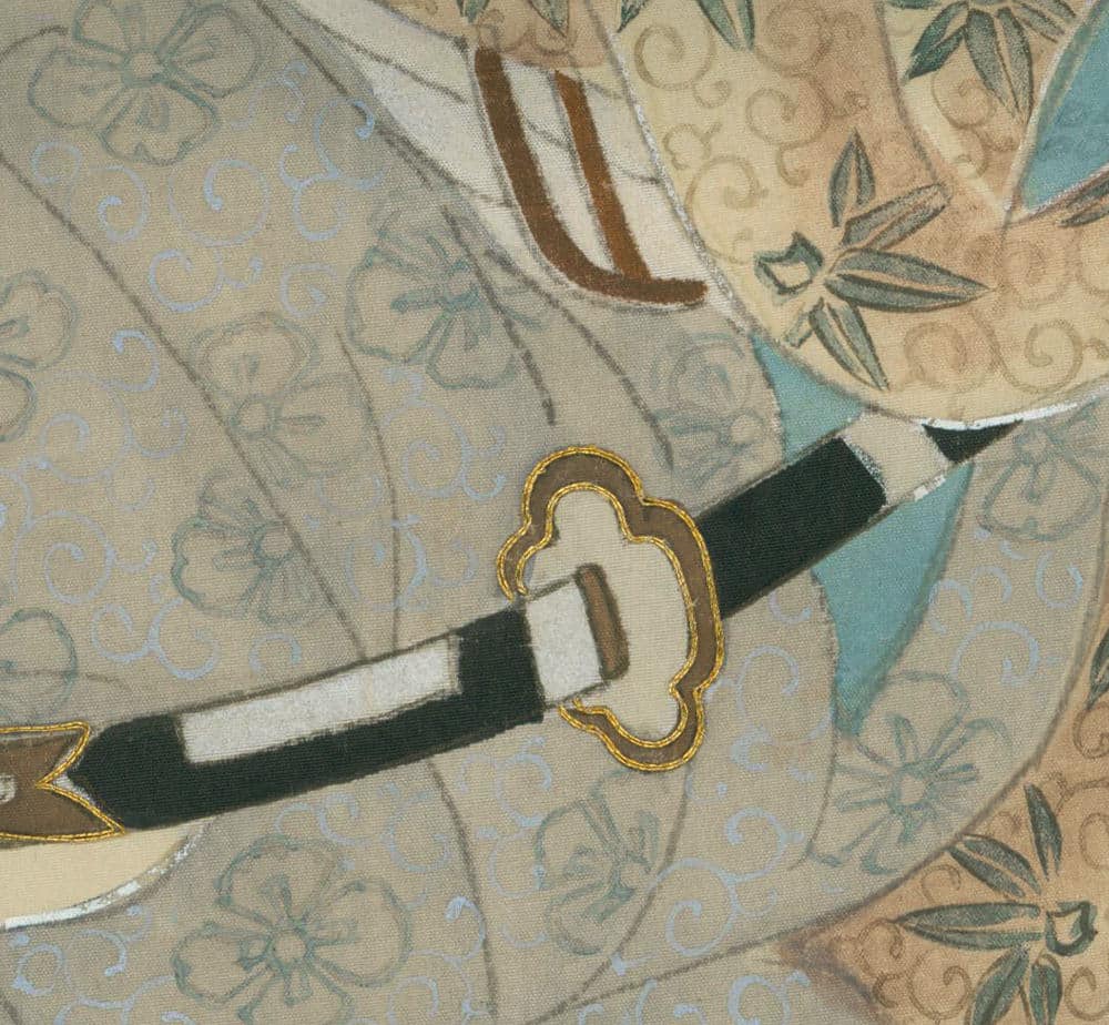 Ornate Japanese sword handle with gold-trimmed guard on floral background