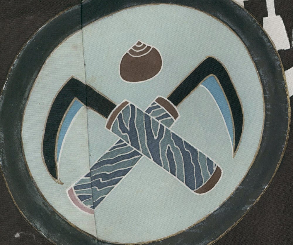 Stylized abstract logo with crossed axes and a circular background