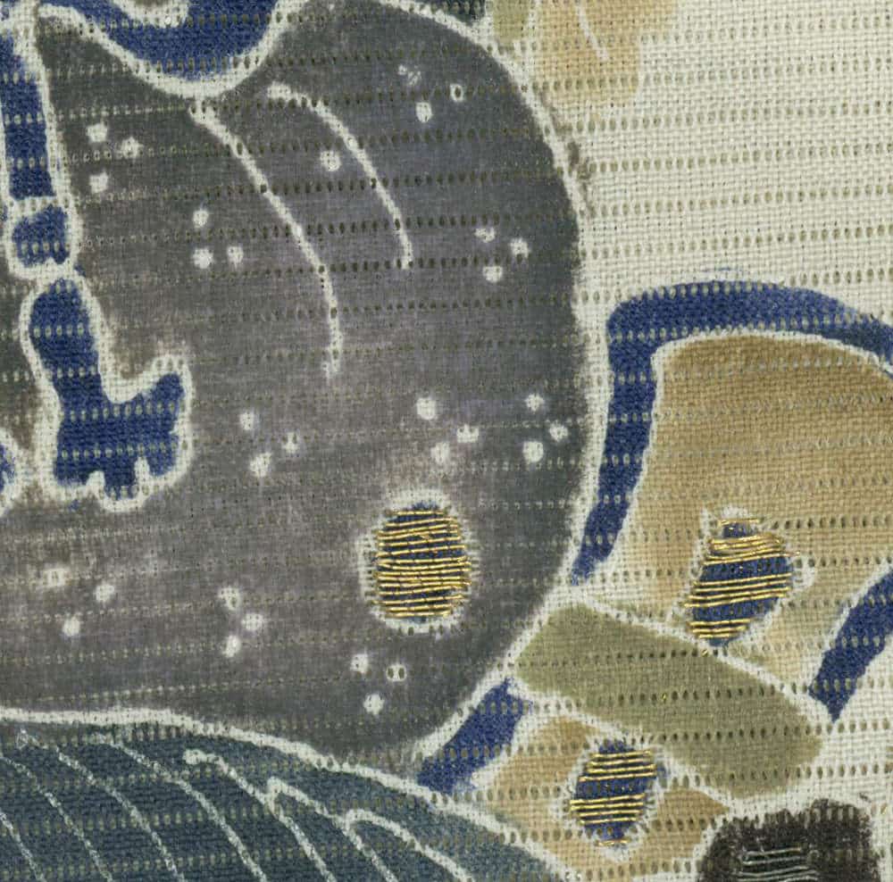 Textured fabric with abstract pattern in gray, blue, and gold tones