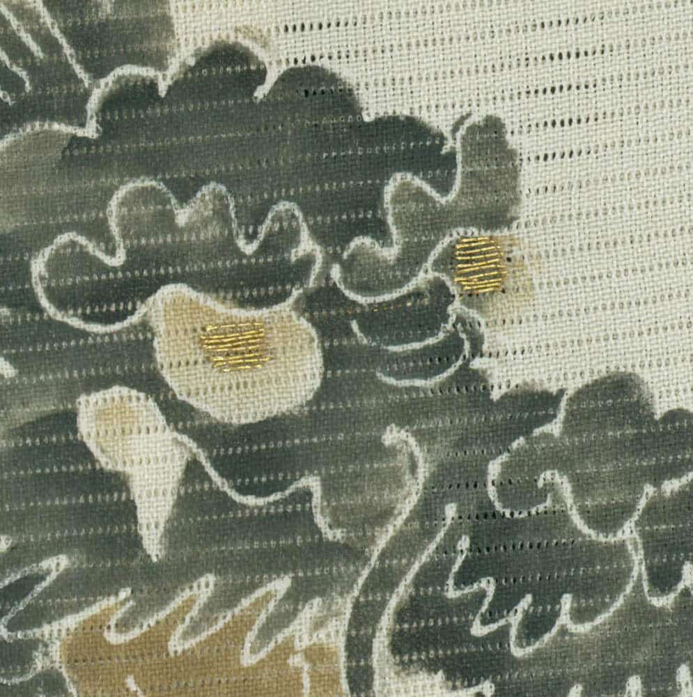 Abstract textile with organic shapes in green, beige, and gold accents