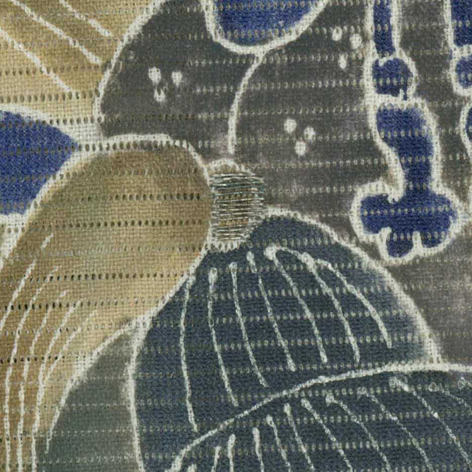 Textured fabric with abstract blue, gray, and beige geometric patterns